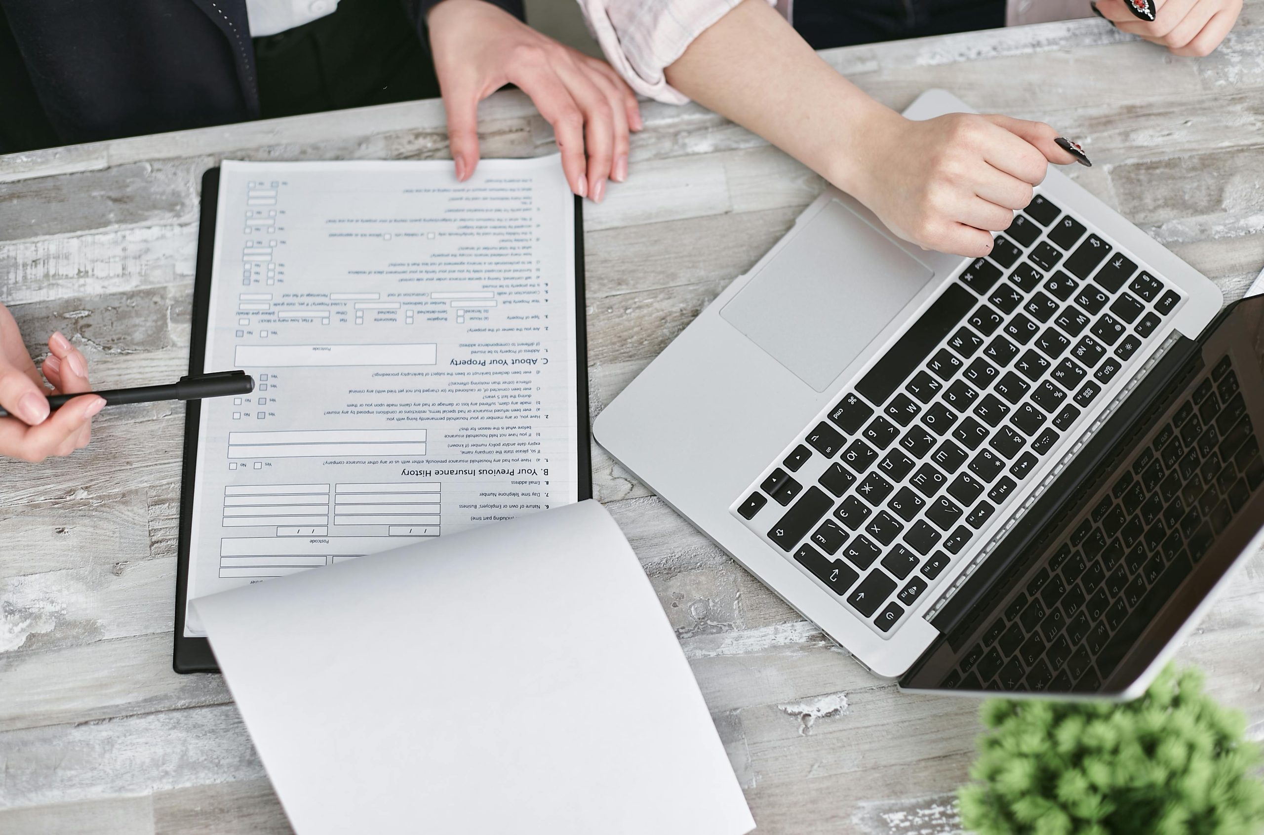 two people filing taxes representing the tax trap that costs business owners millions